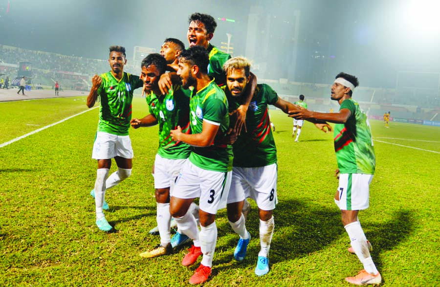 Players of Bangladesh National Football team celebrating after scoring a goal against Sri Lanka National Football team in their Group-A match of the Bangabandhu Gold Cup International Football Tournament at the Bangabandhu National Stadium on Sunday.
