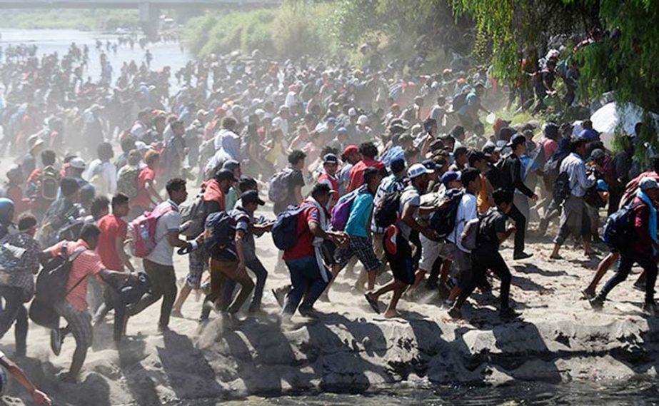 Migrants crossing the Suichate River, the natural border between Guatemala and Mexico.
