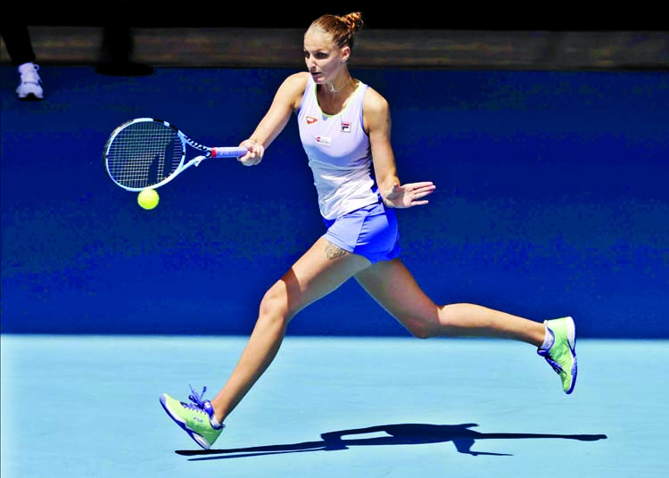 Karolina Pliskova of the Czech Republic, makes a forehand return to France's Kristina Mladenovic during their first round singles match at the Australian Open tennis championship in Melbourne of Australia on Tuesday.
