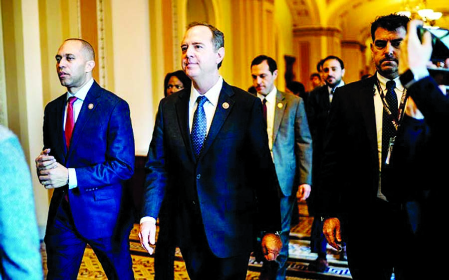 Reps Hakeem Jeffries, left, and Adam Schiff walk with other House impeachment managers to do a walkthrough of the Senate floor and their office space on the Senate side of the Capitol they will use during the impeachment trial of PresidentTrump in Washing