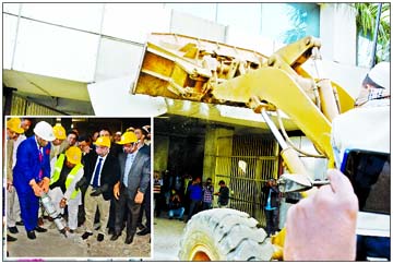 The demolition work of BGMEA Bhaban formally started on Wednesday as Housing and Public Works Minister SM Rezaul Karim inaugurating the work (inset).