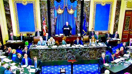 Supreme Court Chief Justice John Roberts presides over the start of the Senate impeachment trial of President Donald Trump as the House impeachment managers sit to one side and the president's legal team sits on the other side in the Senate Chamber Inte