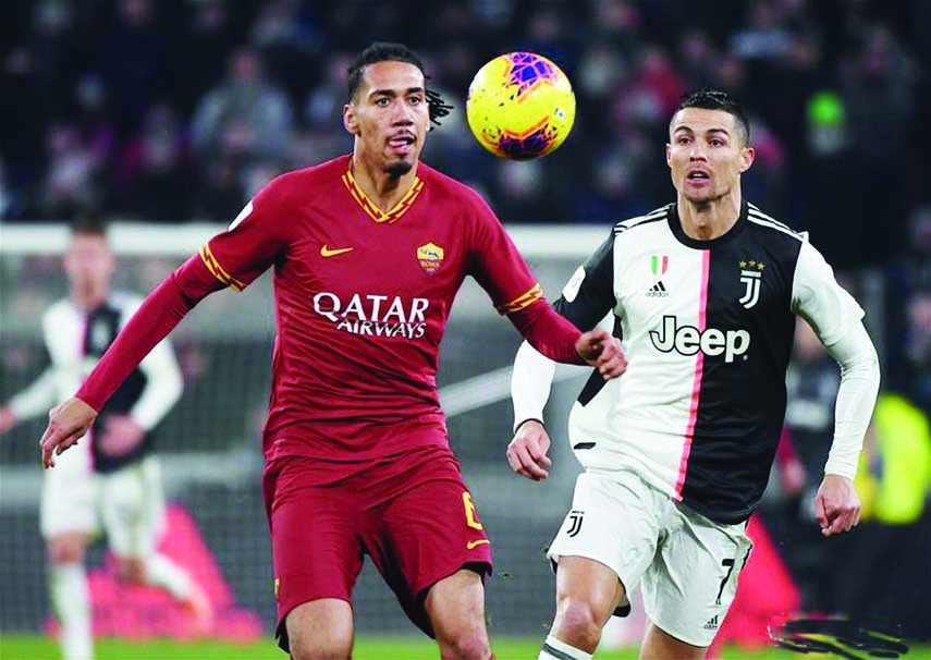 FC Juventus' Cristiano Ronaldo (right) vies with Roma's Chris Smalling during the Italy Cup Quarterfinal football match between FC Juventus and Roma in Turin, Italy on Wednesday.