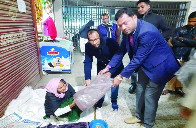 NETRAKONA: Azharul Islam Arun, Convener, Muktijoddah Santan Command, Netrakona Pourashav Unit distributing blankets and winter clothes among poor floating people on Friday.