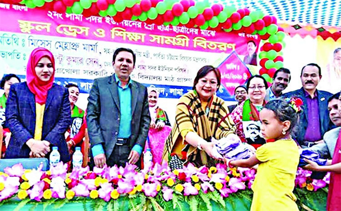 Hla May Prue Marma, wife of Chittagong Hill Tracts Affairs Minister Bir Bahadur distributing educational materials among students in Bandarban as Chief Guest at a function in Merakhola Govt Primary School field on Wednesday noon.