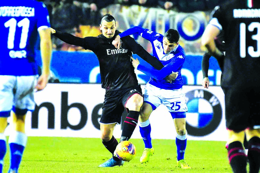 AC Milan's Zlatan Ibrahimovic (left) vies for the ball with Brescia's Bisoli Dimitri, during a Serie A soccer match between Brescia and AC Milan, at Brescia in Italy on Friday.