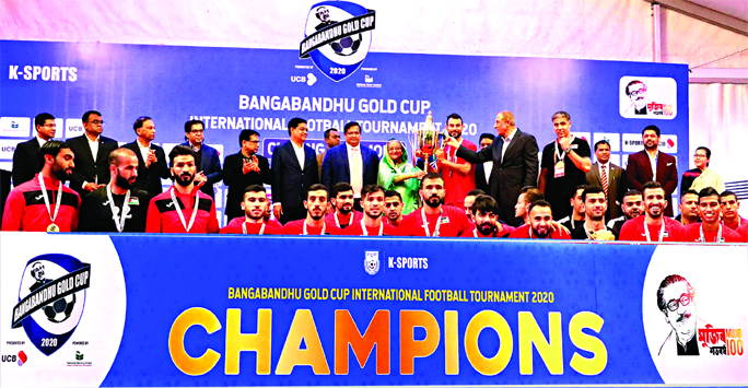 Prime Minister Sheikh Hasina handing over the Championship Trophy of Bangabandhu Gold Cup International Football tournament to Palestine Football team at the Bangabandhu National Stadium on Saturday.