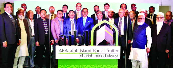 Abdus Samad Labu, Chairman of Al-Arafah Islami Bank Limited (AIBL), poses for photograph after unveiling its new logo and and re-branding campaign at a hotel in the city on Sunday. Farman R. Chowdhury, CEO and other directors of the bank were also present