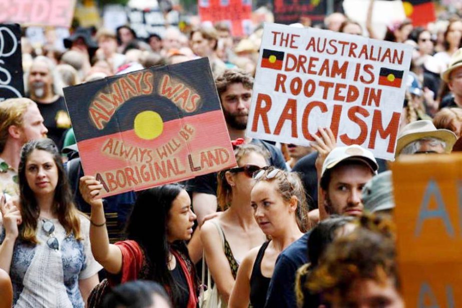 Protesters march during the Invasion Day rally in Melbourne on Sunday.