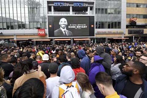 People gather outside Staples Center in Los Angeles on Sunday after the death of Laker legend Kobe Bryant.