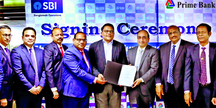 Rahel Ahmed, CEO of Prime Bank Limited (PBL) and Dinesh Kumar Khara, Managing Director of Global Banking and Subsidiaries of State Bank of India (SBI), exchanging document after signing the Short Term Foreign Currency Loan Facility agreement in the city r