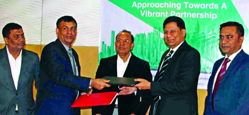 Rajesh Surana, CEO of LafargeHolcim Bangladesh Limited (LHBL) and Commodore Bipan Kumar Saha, CEO of Borak Real Estate Limited (a sister concern of Unique Group), exchanging document after signing an agreement at The Westin, Dhaka on Sunday. Under the dea