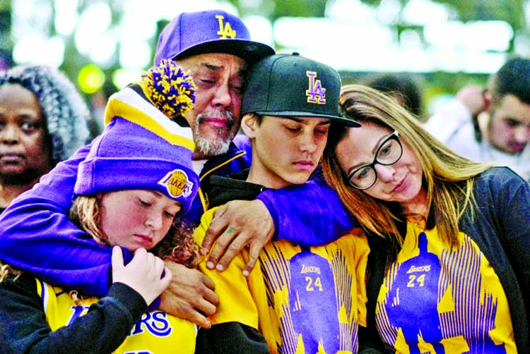 Fans pay respect at a memorial for Kobe Bryant near Staples Center in Los Angeles on Monday. Bryant, the 18-time NBA All-Star who won five championships and became one of the greatest basketball players of his generation during a 20-year career with th