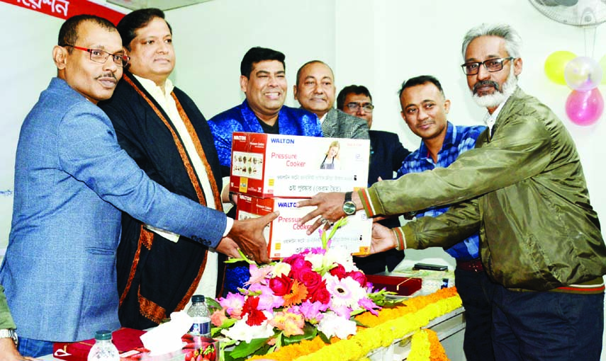 Moin Ahamed (right) and Babul (second from right) duo receiving the prize from the chief guest State Minister for Youth and Sports Zahid Ahsan Russell (second from left) at the Auditorium in Bangladesh Photo Journalists' Association (BPJA) on Wednesday.