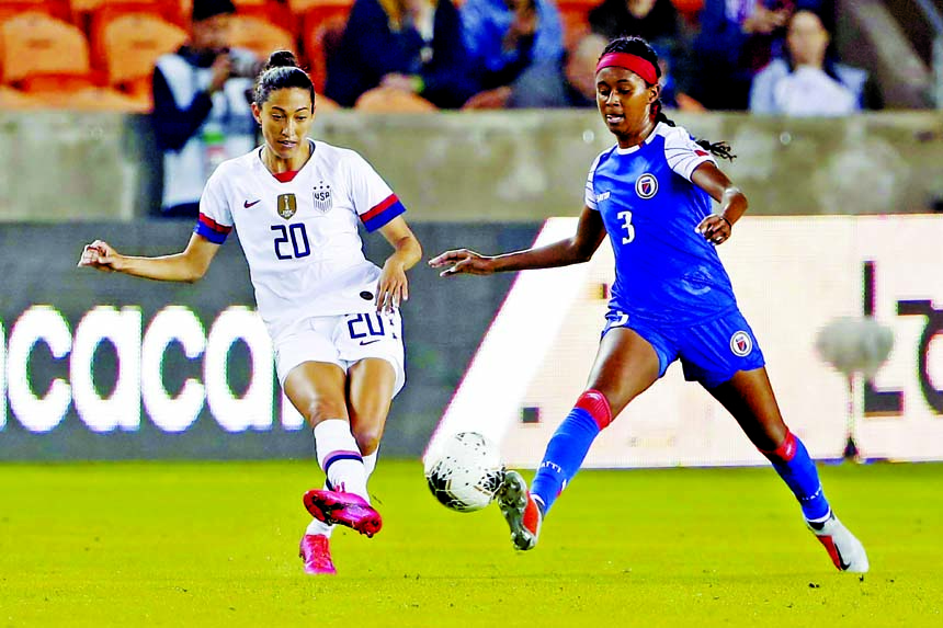 United States forward Christen Press (20) passes the ball in front of Haiti defender Chelsea Surprise (3) during the first half of a women's Olympic qualifying soccer match in Houston on Tuesday.