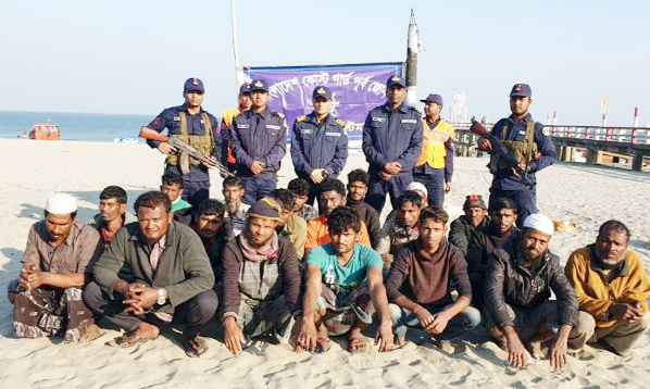 Some 32 missing fishermen of two fishing trawlers posed for a photo session after they were handed over by Myanmar Navy to the members of Coast Guard at St. Martin on Sunday.