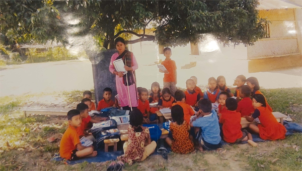 Students attending classes under a tree as there is no school at Tripura Palli in Fatikchhari Upazila in Chattogram.