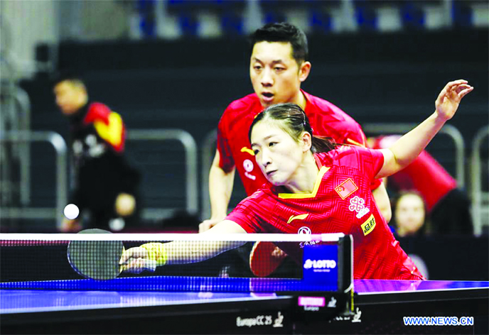 Xu XinLiu Shiwen (bottom) of China, compete during the mixed doubles round of 16 match against Adam SzudiSzandra Pergel of Hungary at the 2020 ITTF World Tour Platinum German Open in Magdeburg, Germany on Thursday.
