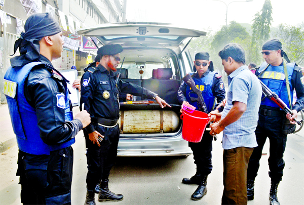 RAB personnel searching vehicles near Basabo intersection in the capital yesterday while carrying out election duties to maintain law and order and ensure a peaceful atmosphere for the Dhaka City Corporation polls.