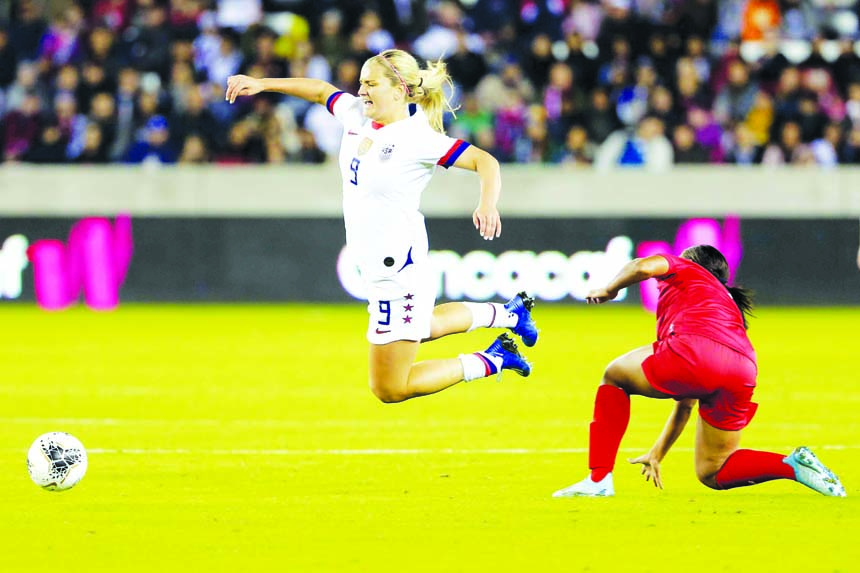 US midfielder Lindsey Horan (9) goes flying after being tripped by Panama defender Hilary Jaen (right) during the first half of a CONCACAF women's Olympic qualifying soccer match in Houston on Friday.