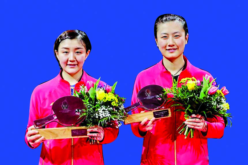 Winner Chen Meng (left) and runner-up Ding Ning of China pose during the awarding ceremony after the women's singles final match at the 2020 ITTF World Tour Platinum German Open in Magdeburg, Germany on Sunday.