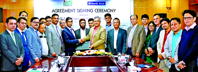 Md. Arfan Ali, Managing Director of Bank Asia Limited and Md. Shafiqul Islam, Managing Director of SME Foundation, exchanging document after signing an agreement to ensure credit at low interest rate to the eligible and potential entrepreneurs of Kumarkha