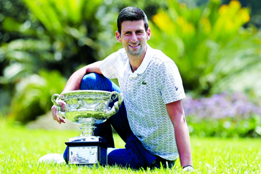 Serbia's Novak Djokovic poses with his trophy, the Norman Brookes Challenge Cup, during a photo shoot at Melbourne's Royal Botanic Gardens following his win over Austria's Dominic Thiem in the men's singles final at the Australian Open tennis champion
