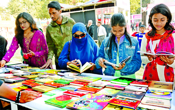 Book lovers browse through books at a stall on the second day of Amar Ekushey Boi Mela on Bangla Academy premises in Dhaka on Monday.