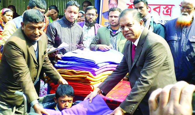 SAGHATA (Gaibandha): Farhad Rabbi, Principal, Bonarpara Government College distributing winter clothes among the disabled students at Saghata Upazila on Monday.