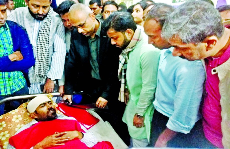 BNP leaders including Tabith Awal and Ishraque Hossain visit journalist Mostafizur Rahman Sumon, who was hacked by miscreants at Rayer Bazar Sadek Khan Road while collecting news regarding the Dhaka City Corporation polls, at Dhaka Medical College Hospita