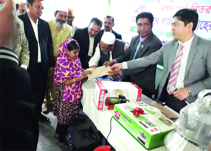 DAMUDYA (Shariatpur): Kazi Abu Taher, DC, Shariatpur and Murtaza -Al- Moin, UNO, Damudya Upazila distributing cash and income generating materisls among baggers at Damudya Officers' Club organised by Upazila Administration yesterday.