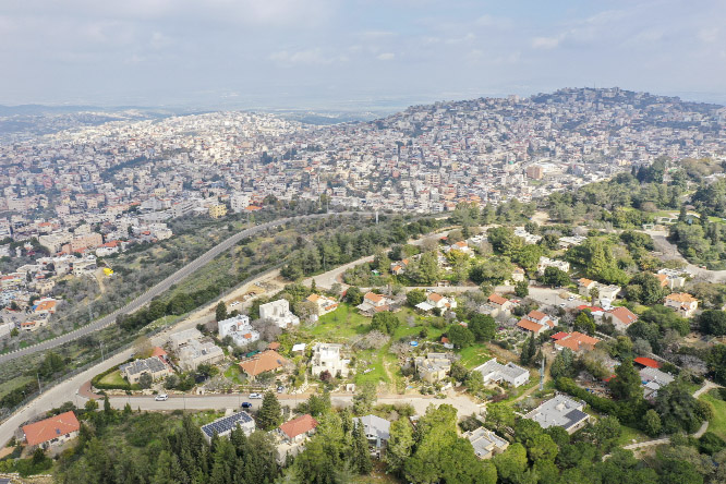 Photo shows the Israeli Arab town of Umm al-Fahm, far back, and the Israeli Moshav of Mei Ami. President Donald Trump's Mideast initiative suggests that the densely populated Arab region of Israel could be added to a future Palestinian state, if both sid