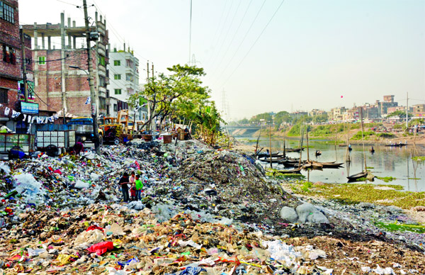 Influential encroachers again trying to grab the land of Buriganga River by dumping huge garbage despite recent govt steps evicting the illegal structures from the areas. This photo was taken from Kamrangir Char on Friday.