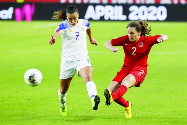 Canada defender Allysha Chapman (right) kicks the ball past Costa Rica forward Melissa Herrera during the second half of a CONCACAF women's Olympic qualifying soccer match at Carson in California on Friday.