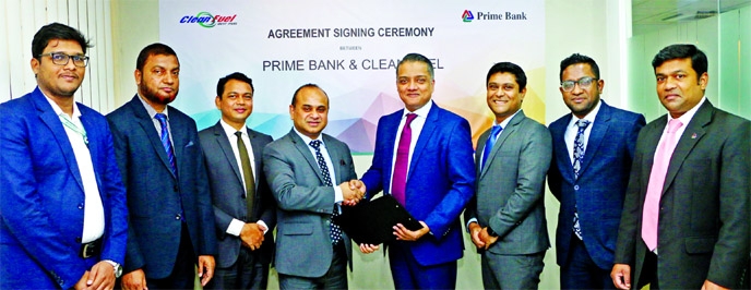 ANM Mahfuz, Head of Consumer Banking Division of Prime Bank and Masudur Rahim, Chief Executive Officer of Clean Fuel Filling Station Ltd, exchanging documents after signing an agreement at the bank's head office recently. Masudul Haque Bhuiyan, Head of C