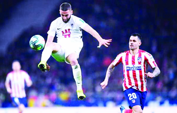 Atletico Madrid's Spanish midfielder Vitolo (right) vies with Granada's Portuguese defender Domingos Duarte during the Spanish league football match between Club Atletico de Madrid and Granada FC at the Wanda Metropolitano stadium in Madrid on Saturday.