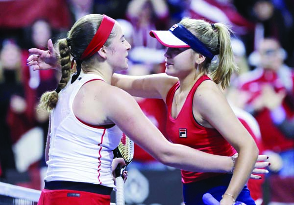United States' Sofia Kenin (right) embraces Latvia's Jelena Ostapenko after Ostapenko defeated her in three sets in a Fed Cup qualifying tennis match at Everett in Washington on Saturday.