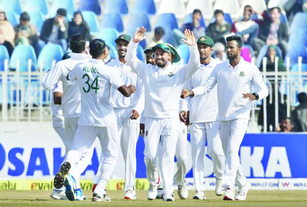 Bangladesh pacer Rubel Hossain (34) celebrates with teammates after taking the wicket of Pakistan batsman Mohammad Rizwan during the third day of their 1st Test cricket match at Rawalpindi Cricket Stadium in Rawalpindi of Pakistan on Sunday.