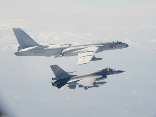 H-6 bomber of Chinese PLA Air Force flies near a Taiwan F-16