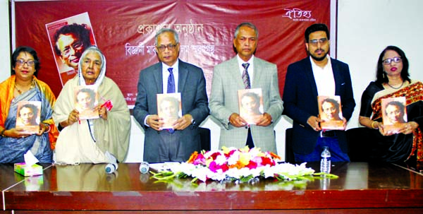 Presidium Member of Awami League Begum Matia Chowdhury, MP, among others, holds the copies of a memorial book of Scientist Maksudul Alam at its cover unwrapping ceremony organised by Oitihya Prokashona at the Jatiya Press Club on Monday.