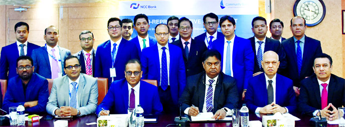 Mosleh Uddin Ahmed, Managing Director of NCC Bank and Masihul Huq Chowdhury, Managing Director of Community Bank, signing a foreign remittance drawing agreement at its head office in the city on Monday. Khondoker Nayeemul Kabir, Deputy Managing Director o