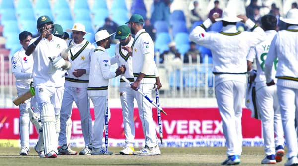 Pakistani players congratulate each other after winning the 1st Test cricket match against Bangladesh at Rawalpindi Cricket Stadium in Rawalpindi of Pakistan on Monday.