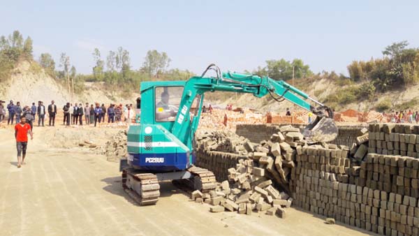 A team of mobile court evicting an illegal brickfield in Lama Upazila on Wednesday.