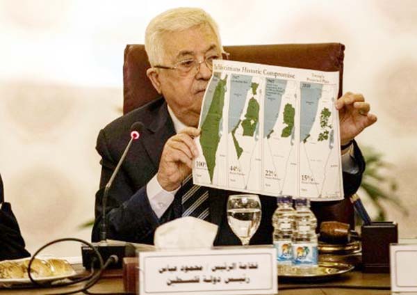 Palestinian President Mahmoud Abbas shows maps of historical Palestine during a February 2020 Arab League meeting on President Donald Trump's proposed Middle East plan.