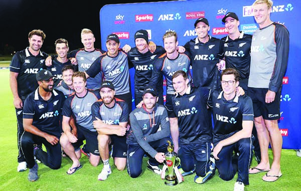 New Zealand's players celebrate with the trophy after victory during the third one-day international cricket match between New Zealand and India at the Bay Oval in Mount Maunganui on Tuesday.