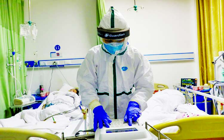 Medical workers in protective suits attend to novel coronavirus patients at the intensive care unit (ICU) of a designated hospital in Wuhan, Hubei province. Internet photo
