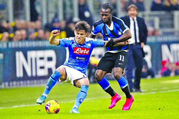 Napoli's Elif Elmas (left) controls the ball as Inter Milan's Victor Moses tries to stop him during an Italian Cup soccer match between Inter Milan and Napoli at the San Siro stadium in Milan of Italy on Wednesday.
