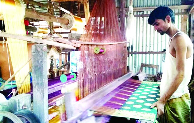 SIRAJGONJ: Zakir Hossain, a handloom owner of Belkuchi Upazila cotinuning only ten looms out of fosty due to manifold problems and proper patronization. This photo was taken yesterday.