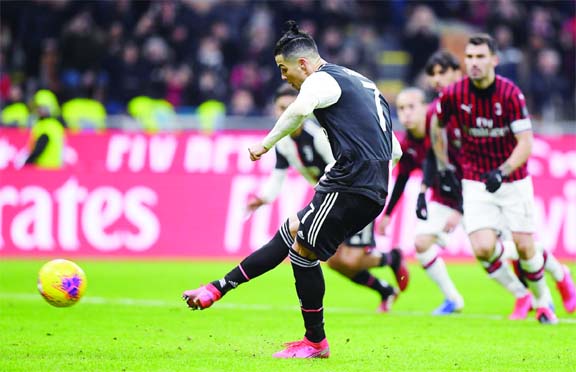 Juventus' Cristiano Ronaldo scores their first goal from the penalty spot during the match against AC Milan at Milan in Italy on Thursday.