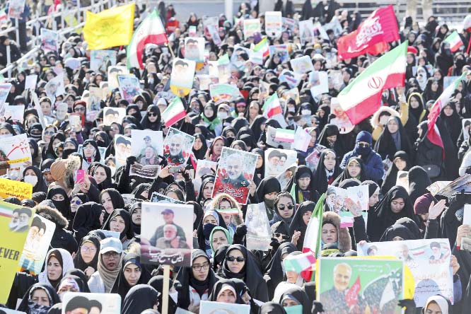 A group of Iranians listen to President Hassan Rouhani during an election campaign ceremony in Tehran, on Wednesday